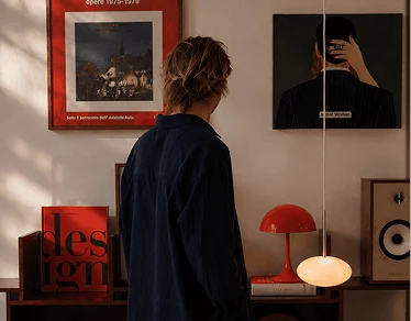 A person looking at the posters on a wall